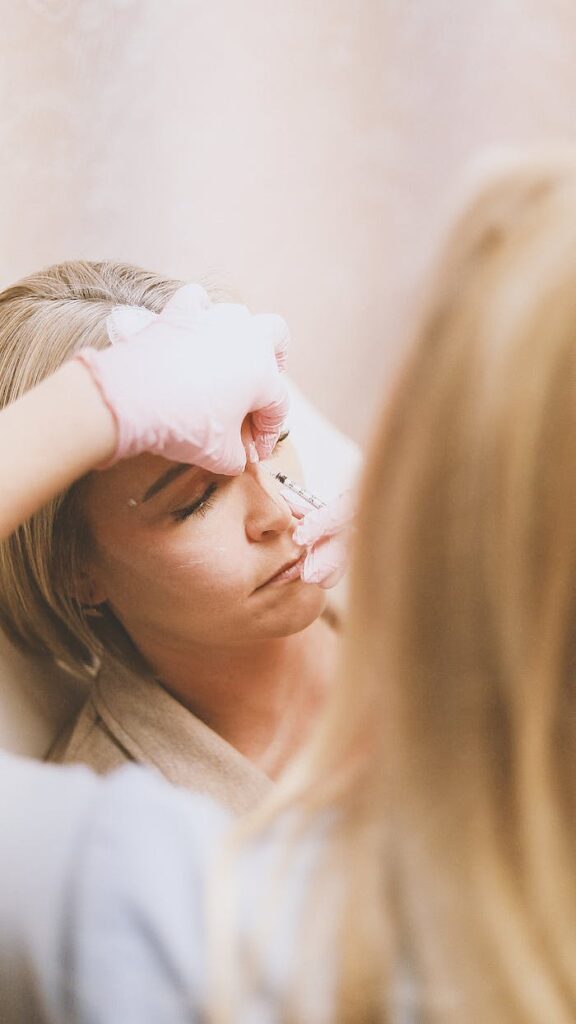 Close-up of a woman receiving a cosmetic injection at a modern beauty clinic.